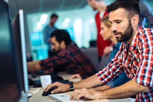 Portait of attractive software designer working in office